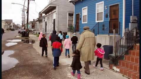 Darryl Durham, head of Anna's Arts for Kids, walks with several children through the Treme neighborhood.