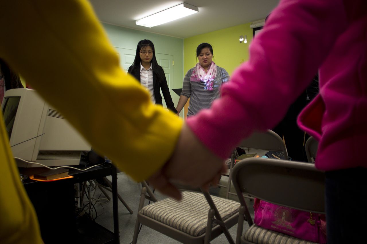 Han's two daughters, EunHye, 20, and JinHye, 24, pray at the Pilgrim Community Church in Virginia. In 1998, the sisters, severely malnourished, walked for three days and crossed the Tumen River to escape into China. They had to leave their younger brother behind in North Korea.