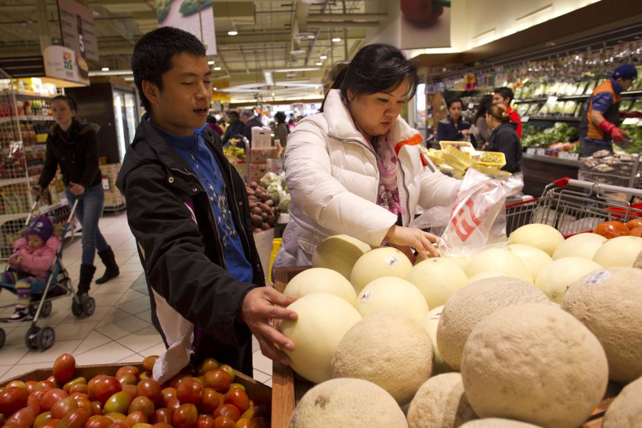 JinHye and her friend, Jacob Seo, also a North Korean defector, pick melons at a Korean supermarket. North Korean defectors form a small community in the D.C. area. 