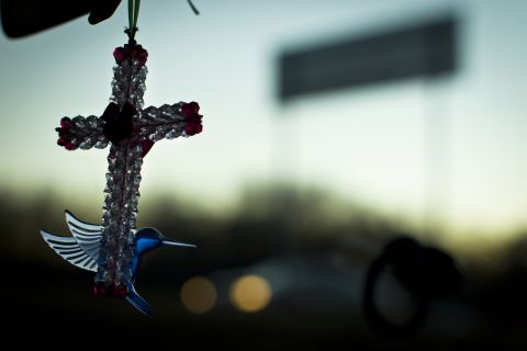 A beaded cross dangles from the rearview mirror of JinHye's car. She made all the crosses so she could sell them to help North Korean refugee efforts.