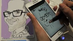 A hostess draws on the Samsung Galaxi Note mobile phone during a presentation in Barcelona.
