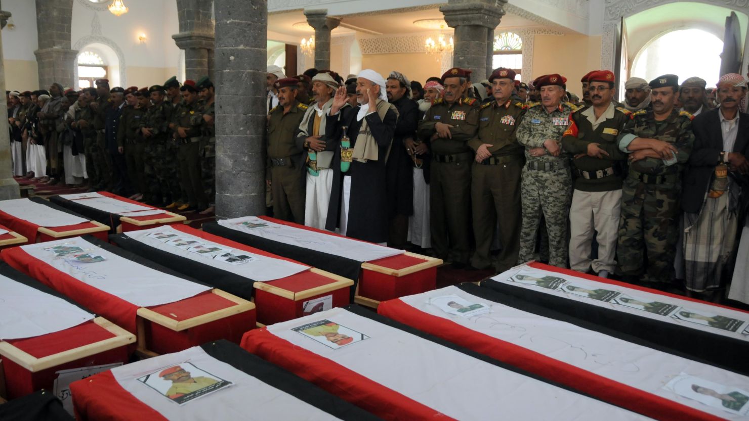 Yemenis pray over the coffins of troops killed when a suicide bomber blew up a vehicle outside a presidential palace in Mukalla on February 27, 2012.