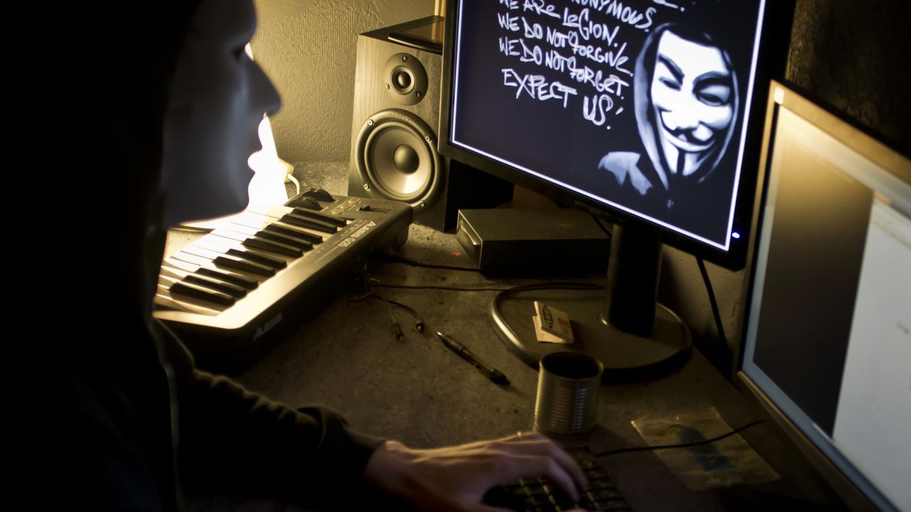 A masked member of 'Anonymous' hacks the French presidential Elysee Palace website in this photo dated January 20, 2012.