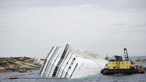 The crippled cruise liner Costa Concordia lies aground near the coast of Italy after striking a reef in January. 