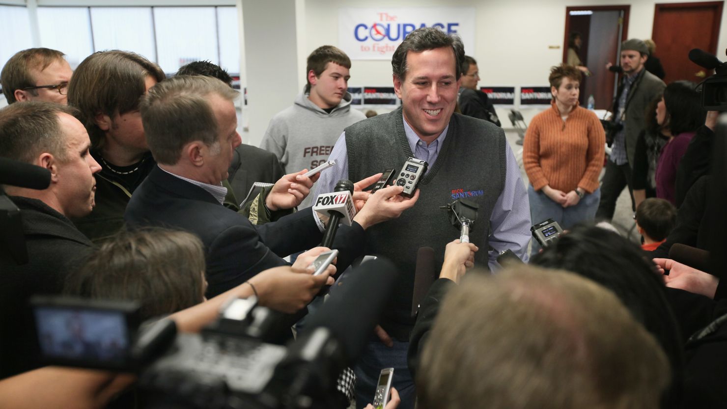 Rick Santorum talks to reporters during a visit to his campaign office in Grand Rapids, Michigan 
