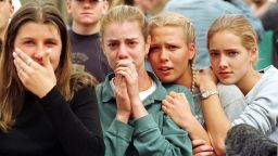 Students from Columbine High School in Littleton, CO watch as the last of their fellow students are evacuated from the school building 20 April 1999 following a shooting spree at the school, which police feared killed as many as 25 people.