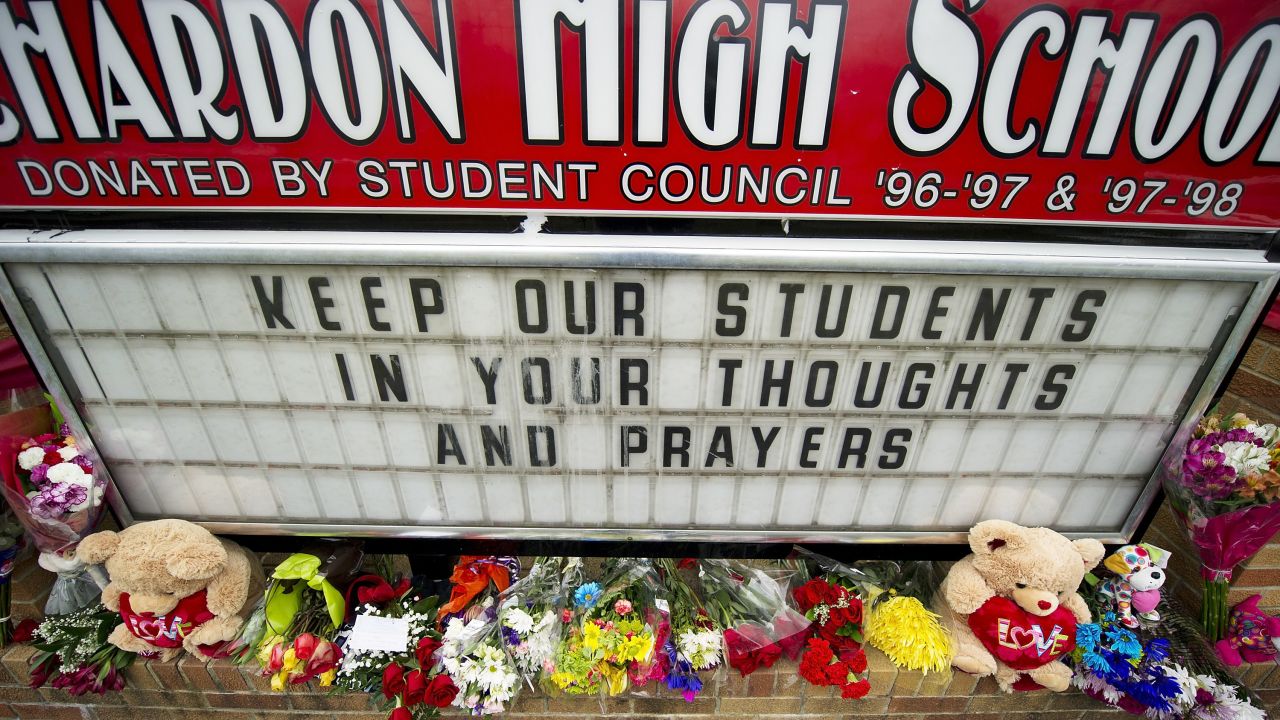 Flowers adorn the sign outside Chardon High School in Ohio on Tuesday.