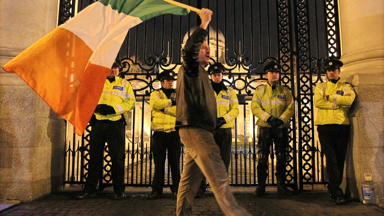 A protester waves an Irish flag outside the Irish Prime Ministers office in Dublin, Ireland, on November 21, 2010.