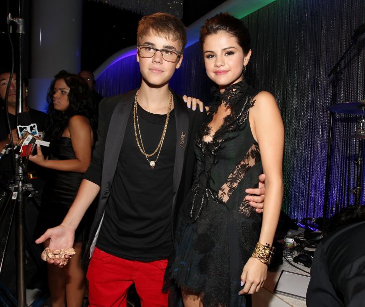 Bieber attends the MTV Video Music Awards in August 2011 with a snake on one hand and then-girlfriend Selena Gomez holding on to the other. He won the best male video award for "U Smile" that night.