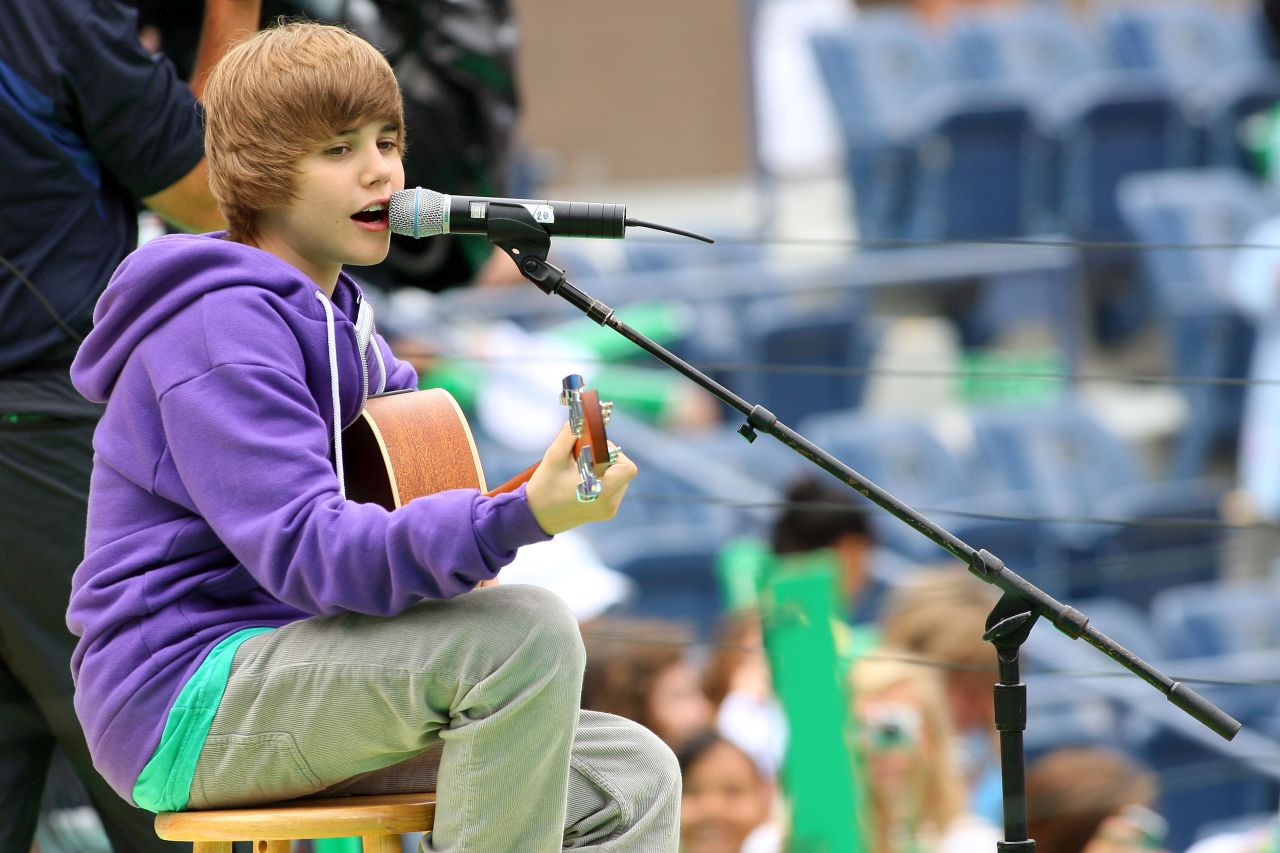 The Stratford, Ontario, native first attracted attention on YouTube. Here Bieber, in his signature purple hoodie, entertains crowds at Arthur Ashe Kids' Day, a U.S. Open event, in New York in August 2009.
