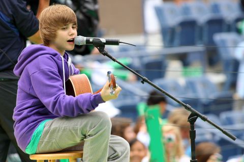 The Stratford, Ontario, native first attracted attention on YouTube. Here Bieber, in his signature purple hoodie, entertains crowds at Arthur Ashe Kids' Day, a U.S. Open event, in New York in August 2009.