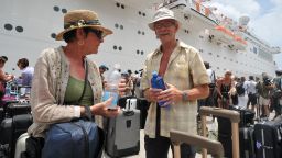 Passengers of the Costa Allegra talk after disembarkment in the harbor of Victoria on March 1, 2012