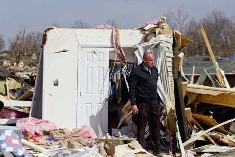 Steve McDonald inspects what's left of his mother-in-law's house in Harrisburg. His in-law, Mary Osman, was among four women and two men killed in the hard-hit town. 