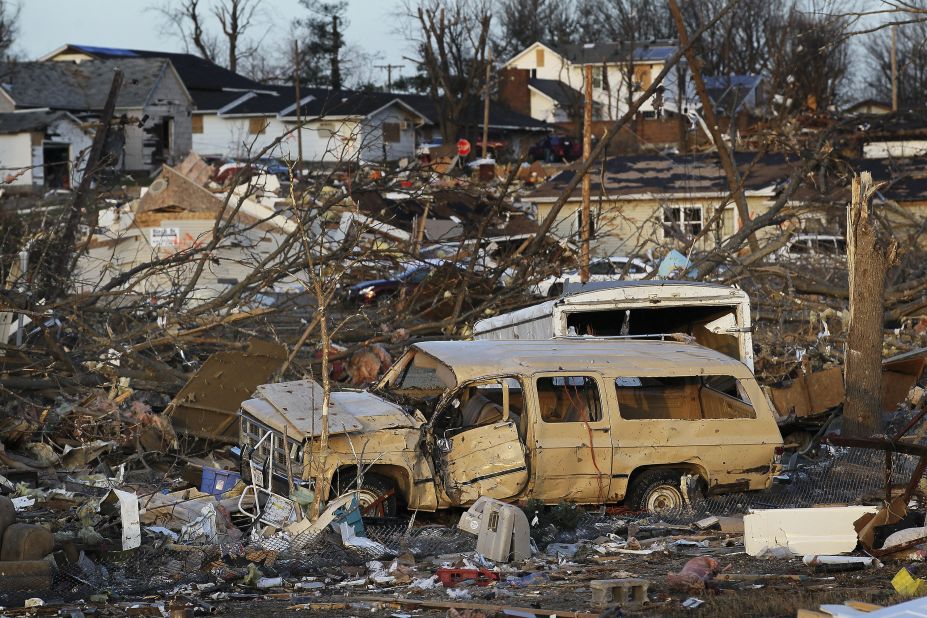 The powerful storm leaves cars tossed about among collapsed houses and other debris Wednesday in Harrisburg.