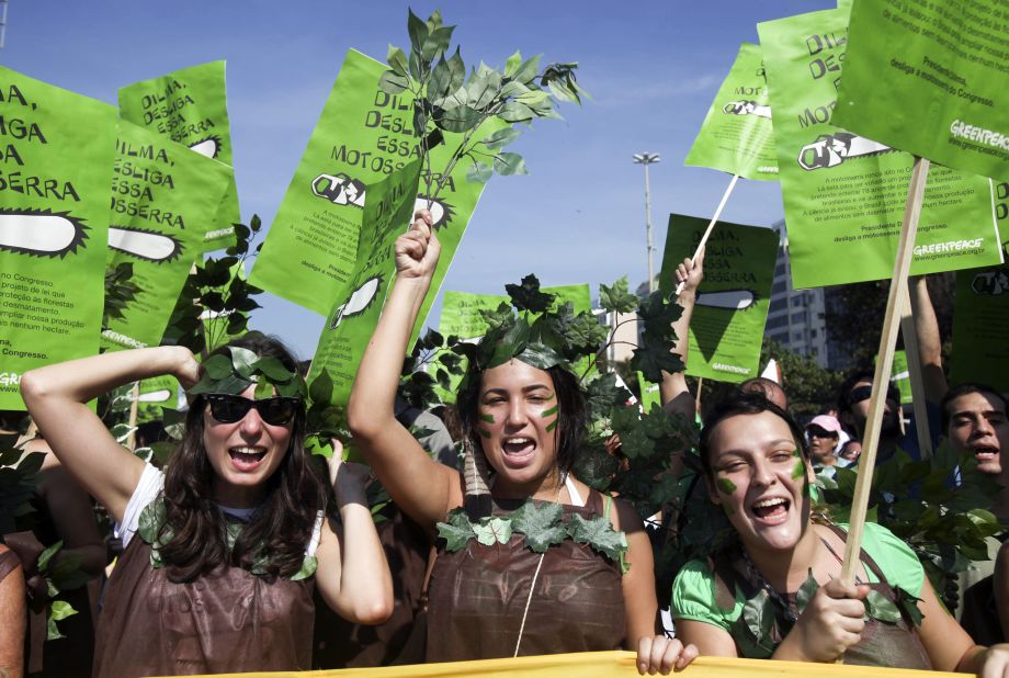 Greenpeace activists march along Rio de Janeiro's Copacabana beach ptotesting Brazil's new Forest Code in June 2011.