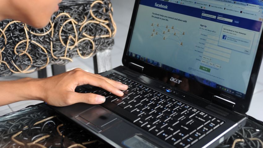 An Indonesian teenager logs on to Facebook at an internet shop in Jimbaran on January 3, 2012. 