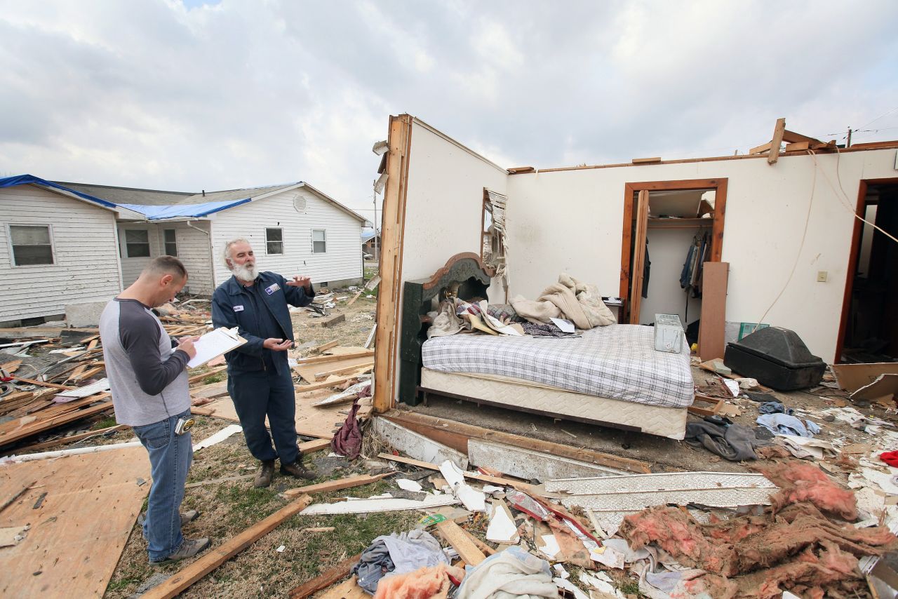 Keith Huke, right, remained in the bed to his left, escaping with no injuries from the tornado that tore apart his home in Harrisburg, Illinois.