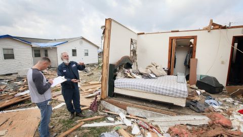 Keith Huke, right, remained in the bed to his left, escaping with no injuries from the tornado that tore apart his home in Harrisburg, Illinois.