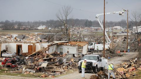 Utility workers try to restore electricity to a tornado-damaged section of Harrisburg on Friday.