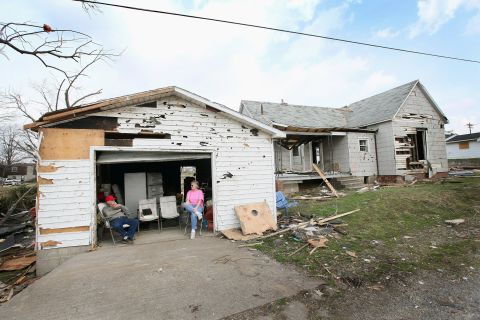 Dale Barnfield, left, and his niece Linda Mayberry wait for an insurance adjuster outside Barnfield's tornado-damaged home in Harrisburg.