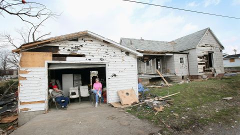Dale Barnfield, left, and his niece Linda Mayberry wait for an insurance adjuster outside Barnfield's tornado-damaged home in Harrisburg.
