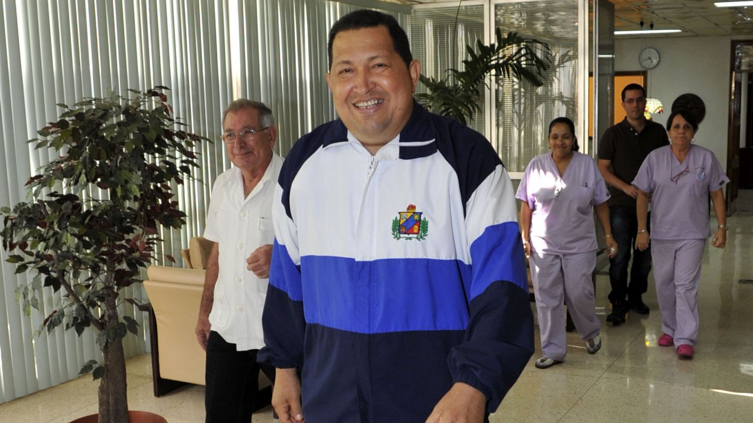 In a photo released Friday, Hugo Chavez walks through the hospital in Havana, Cuba, where he was treated.