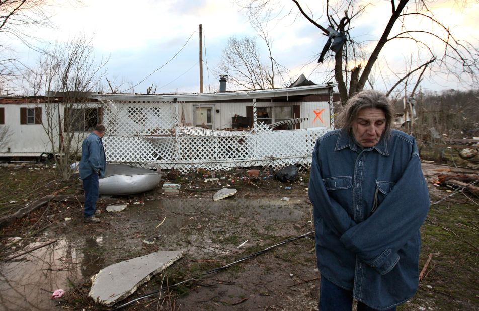 Steve Smith and J. J. Smith survey the damage to their home following the tornado that struck Henryville.