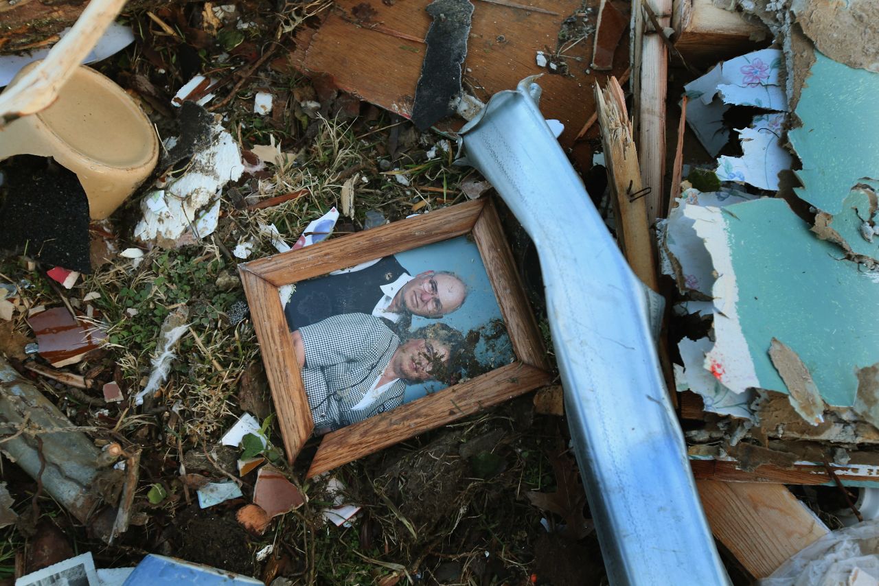 A family portrait sits among the debris of a Henryville home.