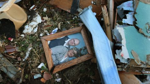 A family portrait sits among the debris of a Henryville home.