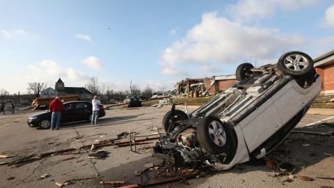 A car and school bus are overturned in the parking lot of a Henryville school.