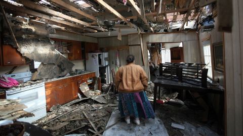 Leah Boylan looks at the damage to her sister's home on Saturday, March 3, after it was destroyed by a tornado in Henryville, Indiana. Dozens of people were killed as severe weather and tornadoes ripped through the South and Midwest on Friday, March 2.
