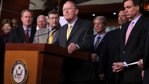 Republican Sen. Lamar Alexander, center, and Democratic Sen. Mark Warner, right foreground, are hosting a series of bipartisan dinners for fellow senators.