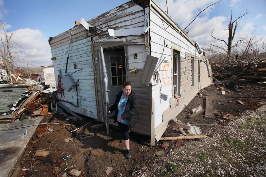 Sarah Kutz helps her sister rescue possessions from her home, which was destroyed in the tornado that hit Henryville.