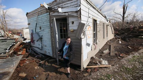 Sarah Kutz helps her sister rescue possessions from her home, which was destroyed in the tornado that hit Henryville.