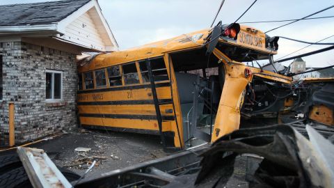 A school bus is lodged in a home in Henryville where it came to rest after being tossed by Friday's tornado.