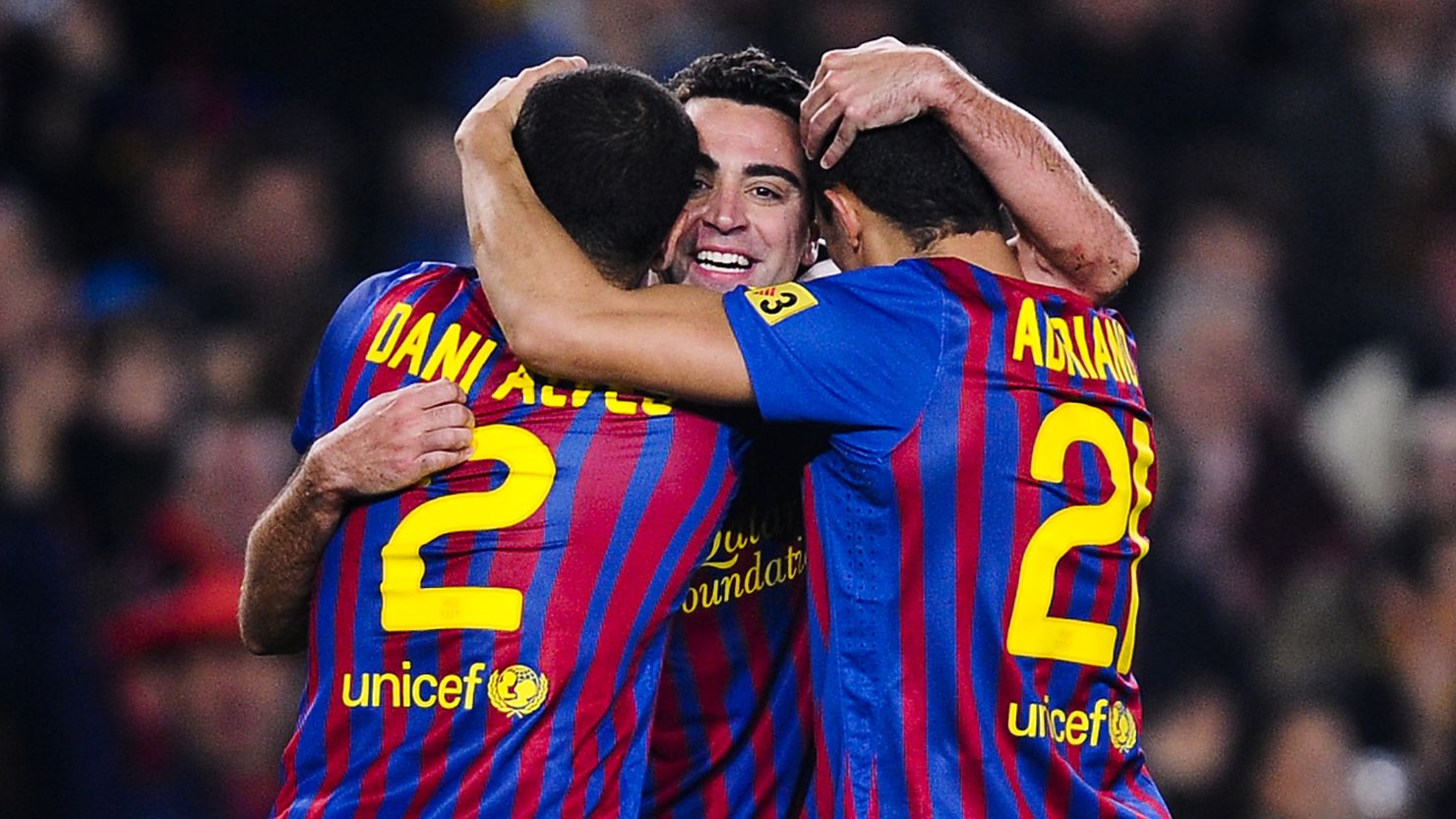 Xavi (center) celebrates with Dani Alves and Adriano as Barcelona beat Sporting Gijon 3-1 at the Nou Camp.
