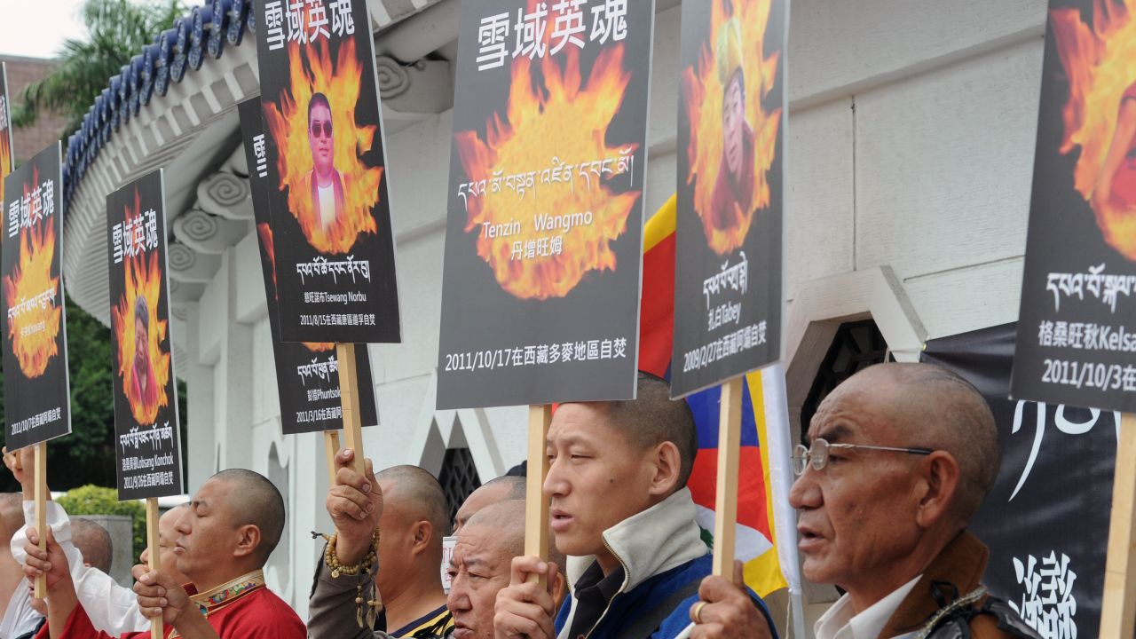 Tibetans display portraits of people who killed themselves in self-immolation, during a protest in front of the Liberty Square in Taipei in October 2011.