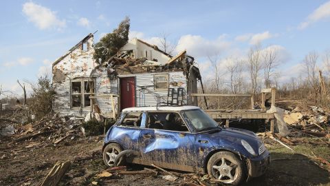 Debris from the violent tornado remains scattered around a Henryville home on Sunday.