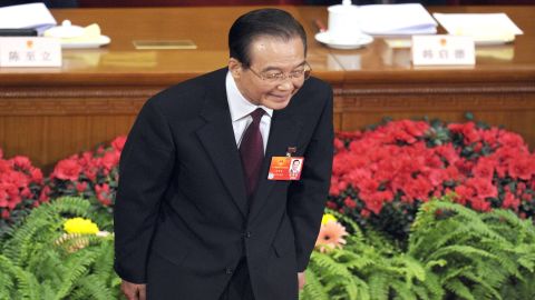 Chinese Premier Wen Jiabao bows to delegates during the opening session of the National People's Congress in Beijing Monday.