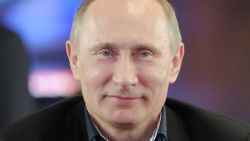 Vladimir Putin smiles during a visit to his presidential campaign staff in Moscow on Sunday.
