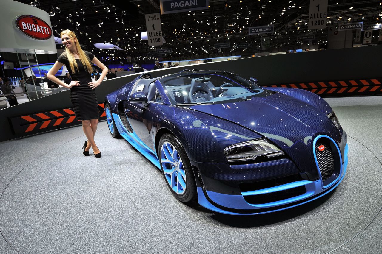 A Bugatti Veyron Grand Sport Vitesse, which has a top speed of 255 miles per hour, is exhibited on a rotating stand.
