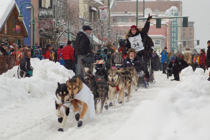 Fans cheer teams Saturday in Anchorage during the race's ceremonial start.