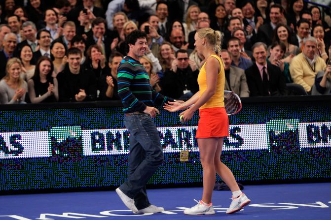 Love match. Caroline Wozniacki welcomes her boyfriend Rory McIlroy onto the court at Madison Square Garden.
