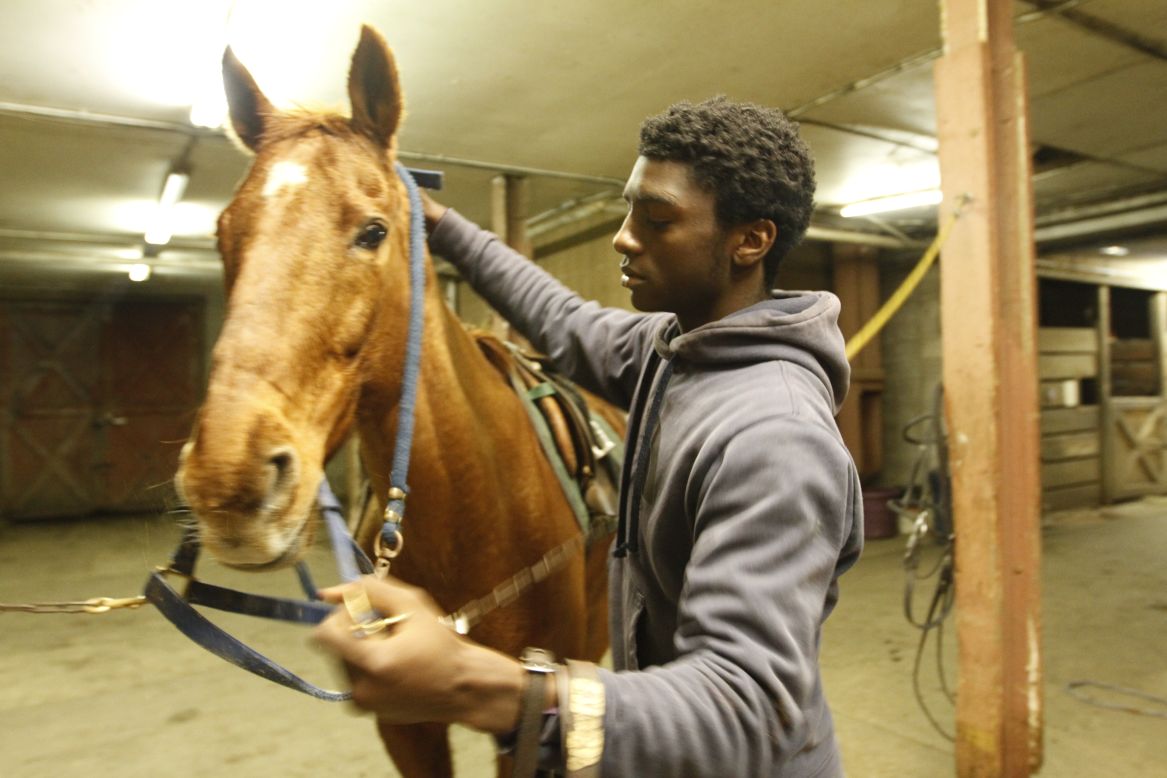 Kenshaun Walker, 15,  tacks up a horse inside the barn at Work To Ride. Tucked away in the heart of Philadelphia's Fairmount Park, the stable has become an urban oasis for at-risk youth, like Walker, who hail from the city's most dangerous neighborhoods. "I don't care if I'm not rich. I don't care if my mother's single. I don't care what I don't have. I'm willing to do anything in life to make it to the pros in polo," he said. 