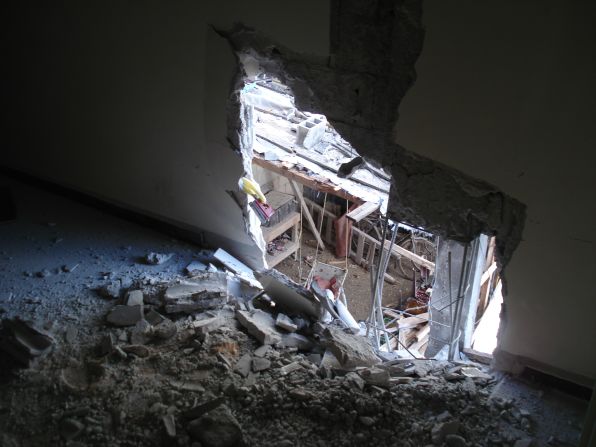 A hole blown in side of a house used by the media in Homs, Syria.