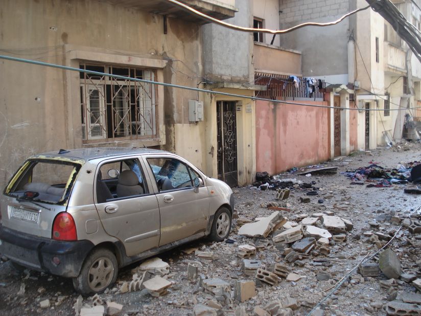 A bombed out car and rubble covers the ground in this street Homs, Syria, where the army has been attacking anti-regime elements.