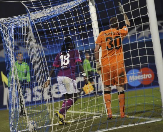 Lyon's Bafetimbi Gomis scored four goals in a Champions League match this season, as the French team squeezed into the knockout stages with a 7-1 win against Dinamo Zagreb.