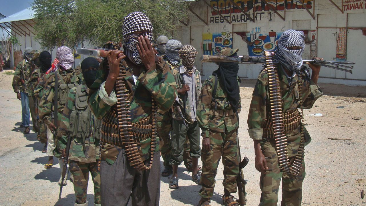 Al-Qaeda linked al-shabab recruits walk down a street on March 5, 2012 in the Deniile district of Somalian capital, Mogadishu, following their graduation. The walls of the former Shebab base in Baidoa, Somalia, are littered with rudimentary drawings of machine guns and tanks, a note reading 'Fear God, don't write on these walls' and a sketch of an Al-Qaeda flag, homage to the rebel group's international allies. The crumbling building is now occupied by Ethiopian troops who nearly two weeks ago forced Shebab rebels out of Baidoa, their former Shebab stronghold and Somalia's third-largest city. AFP PHOTO/Mohamed ABDIWAHAB (Photo credit should read Mohamed Abdiwahab/AFP/Getty Images)