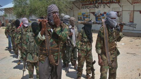 Al-Shabaab recruits walk down a street in Mogadishu, Somalia. The group is blamed for attacks and kidnappings of foreigners in Kenya.