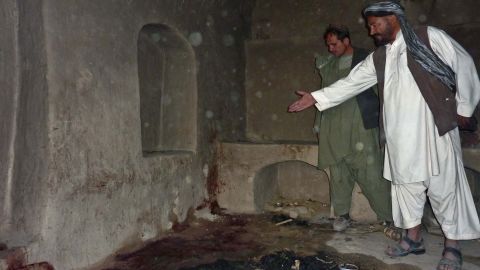 A man points to the spot where he says a family was shot in Kandahar province, Afghanistan, on March 11 